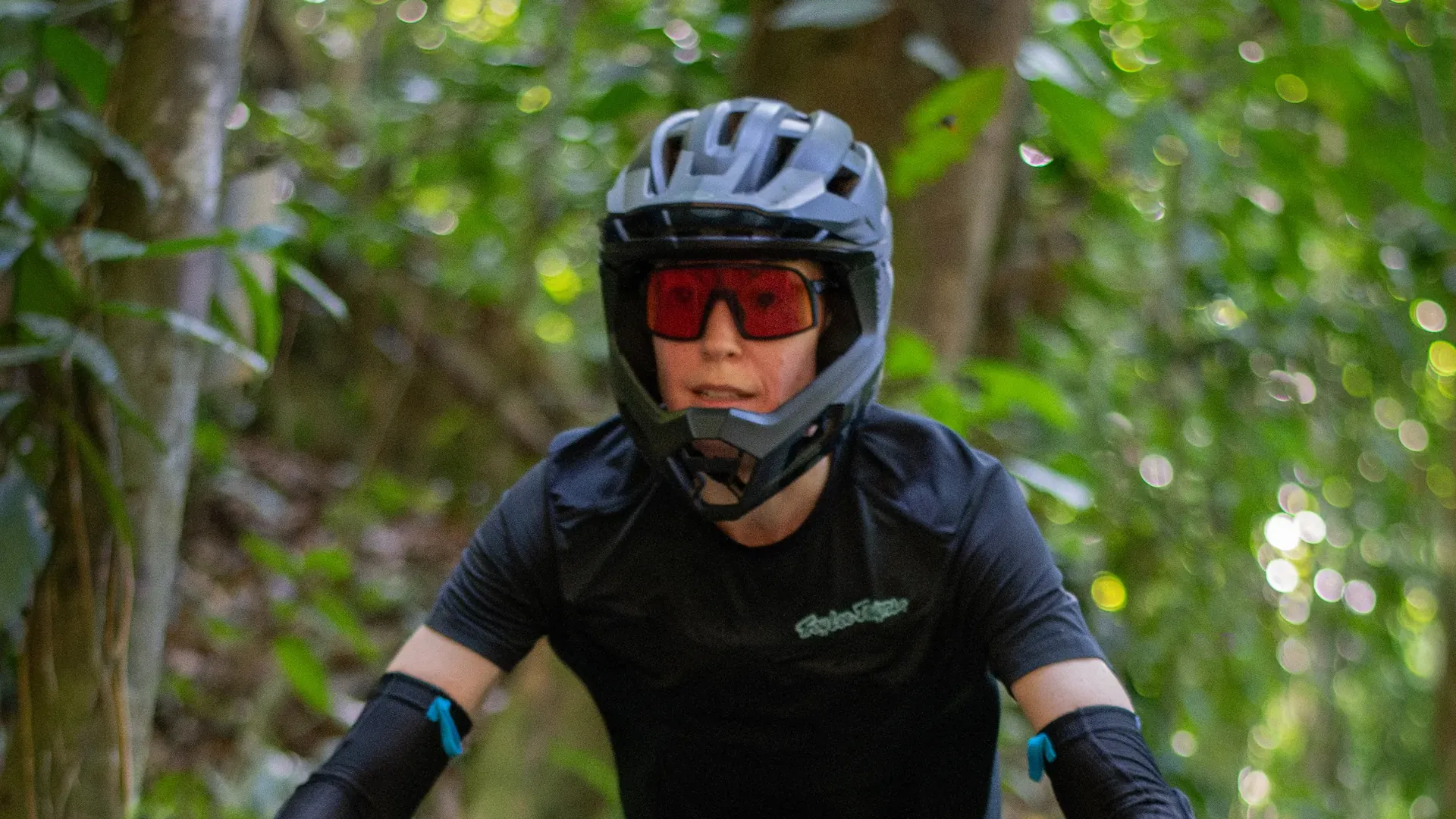 Enduro rider in a full-face helmet on technical jungle trails at Rafiki Safari Lodge, Costa Rica