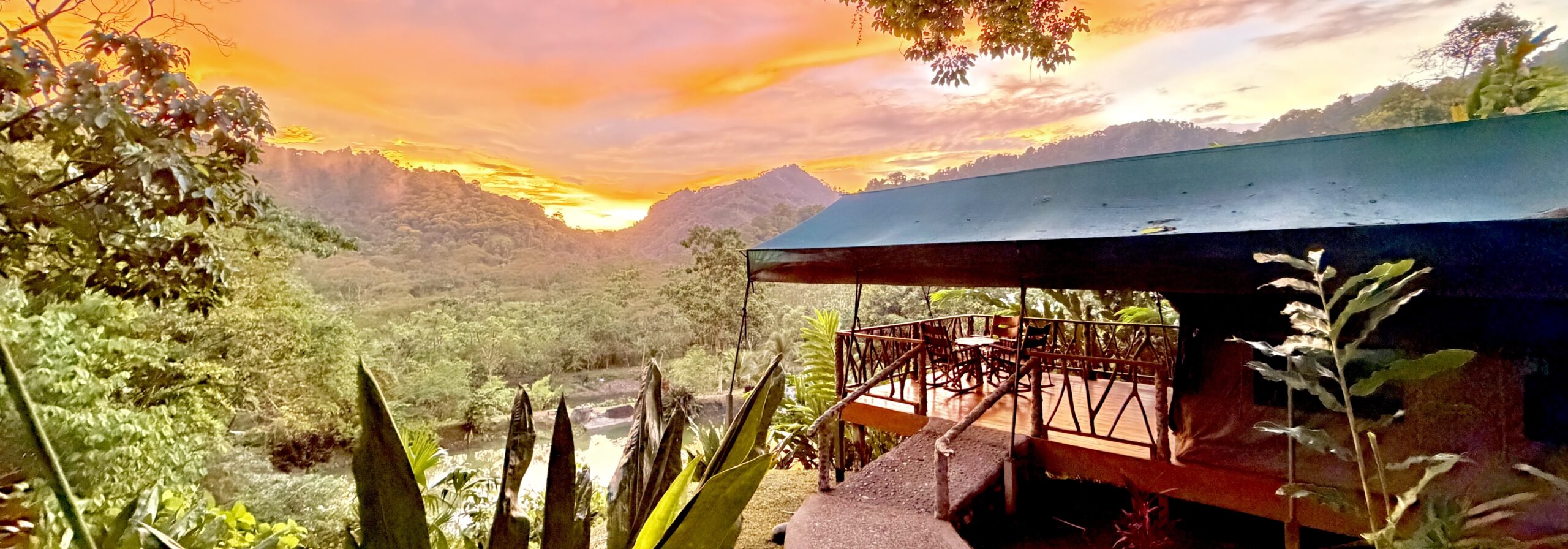 Safari tent deck at sunset overlooking the Savegre Valley rainforest